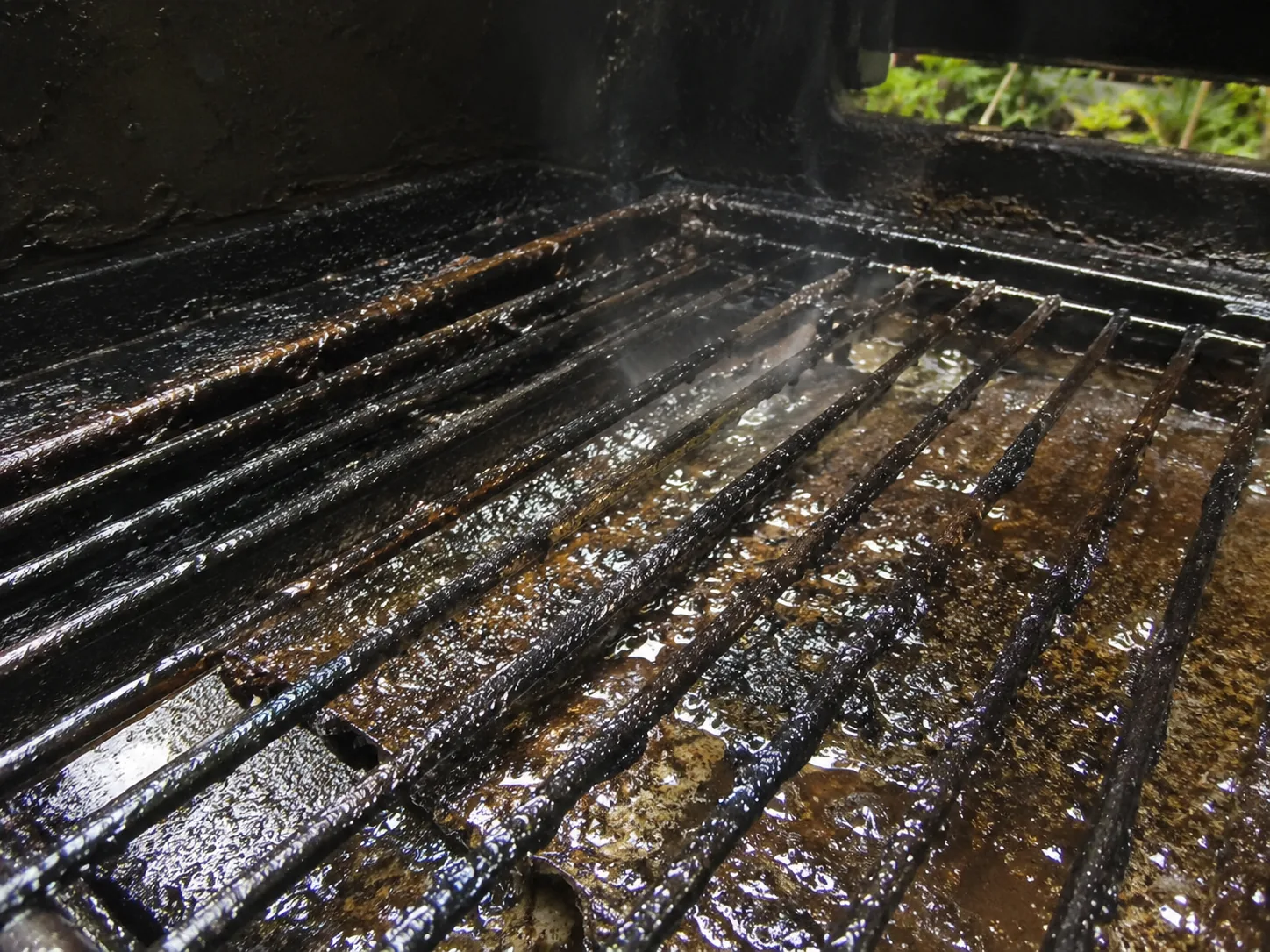 Grease buildup inside BBQ grill before cleaning and repair