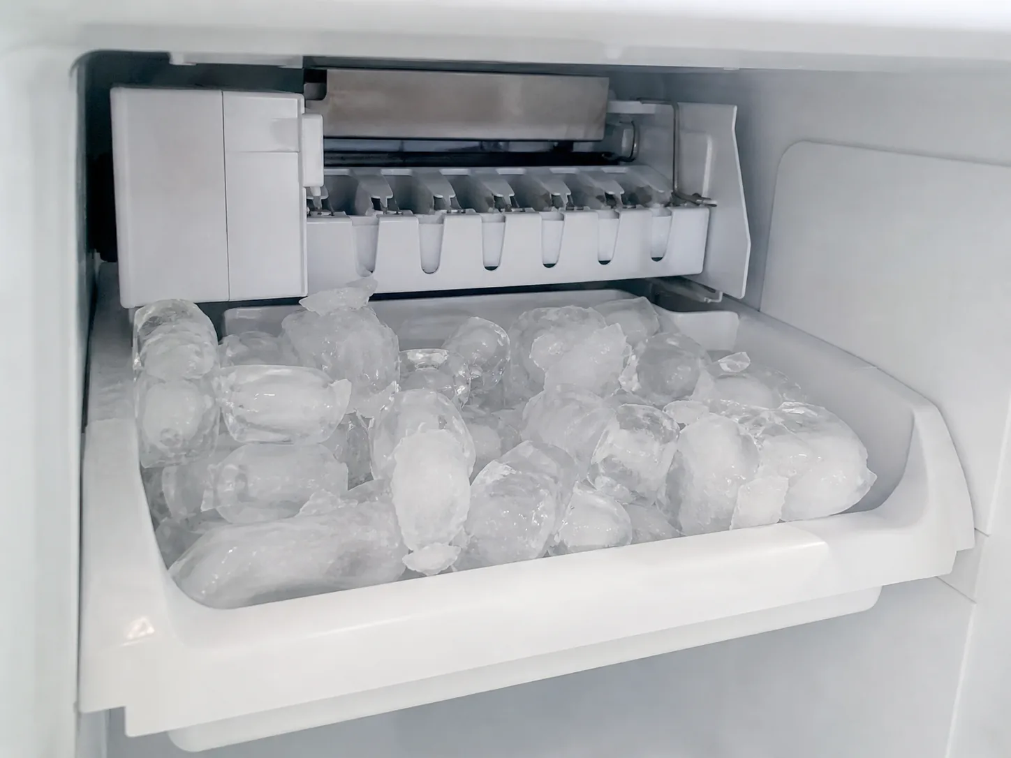 Ice maker bin with ice cubes after production check