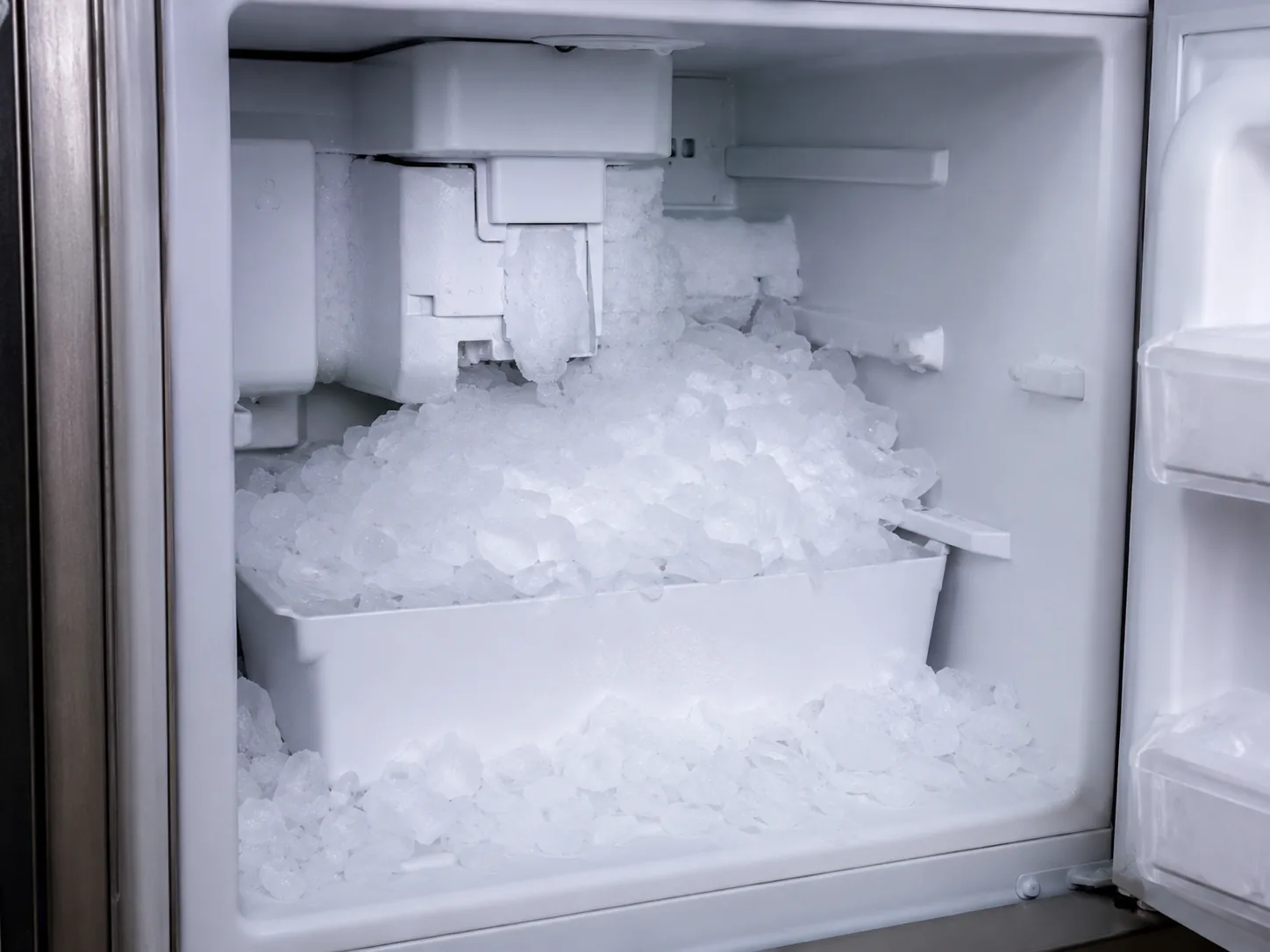 Freezer ice maker with excess ice buildup